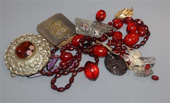 Assorted items including simulated amber necklaces and a silver belt buckle.